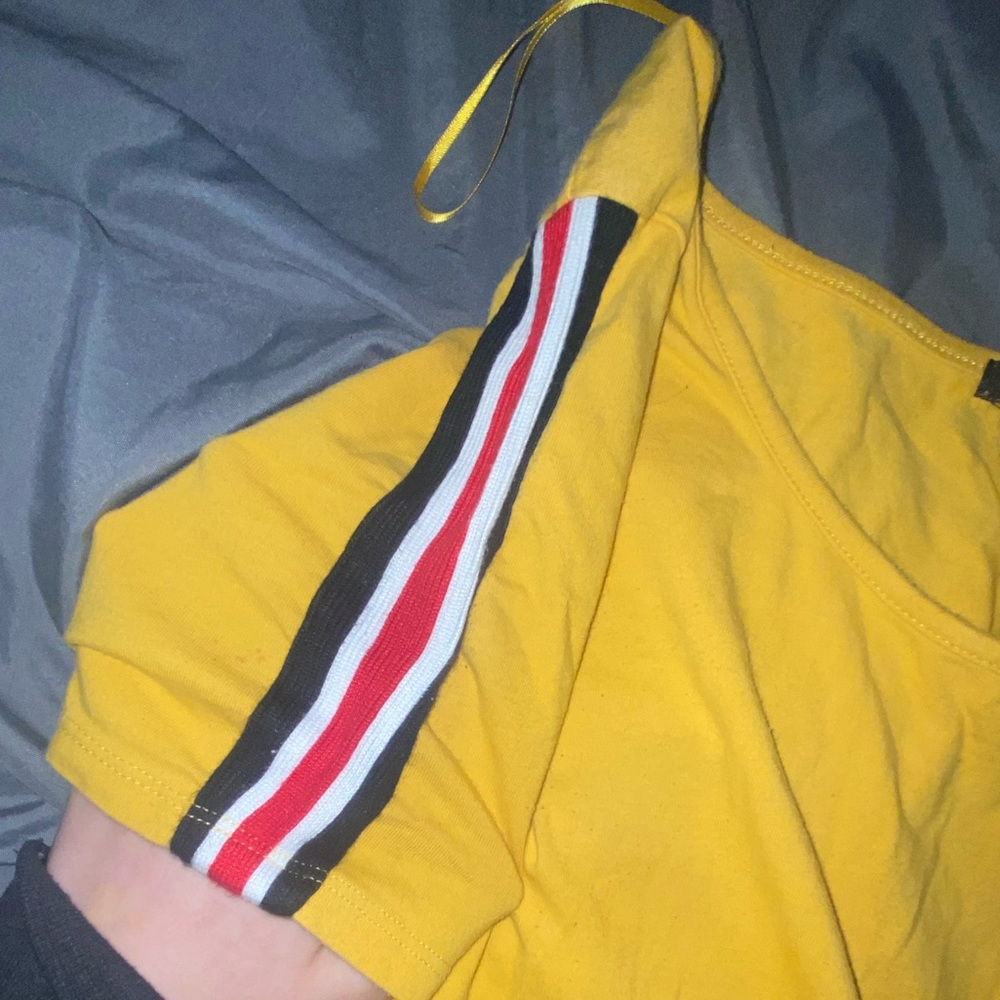 Orange body suit with black,red,white strips on the sleeves